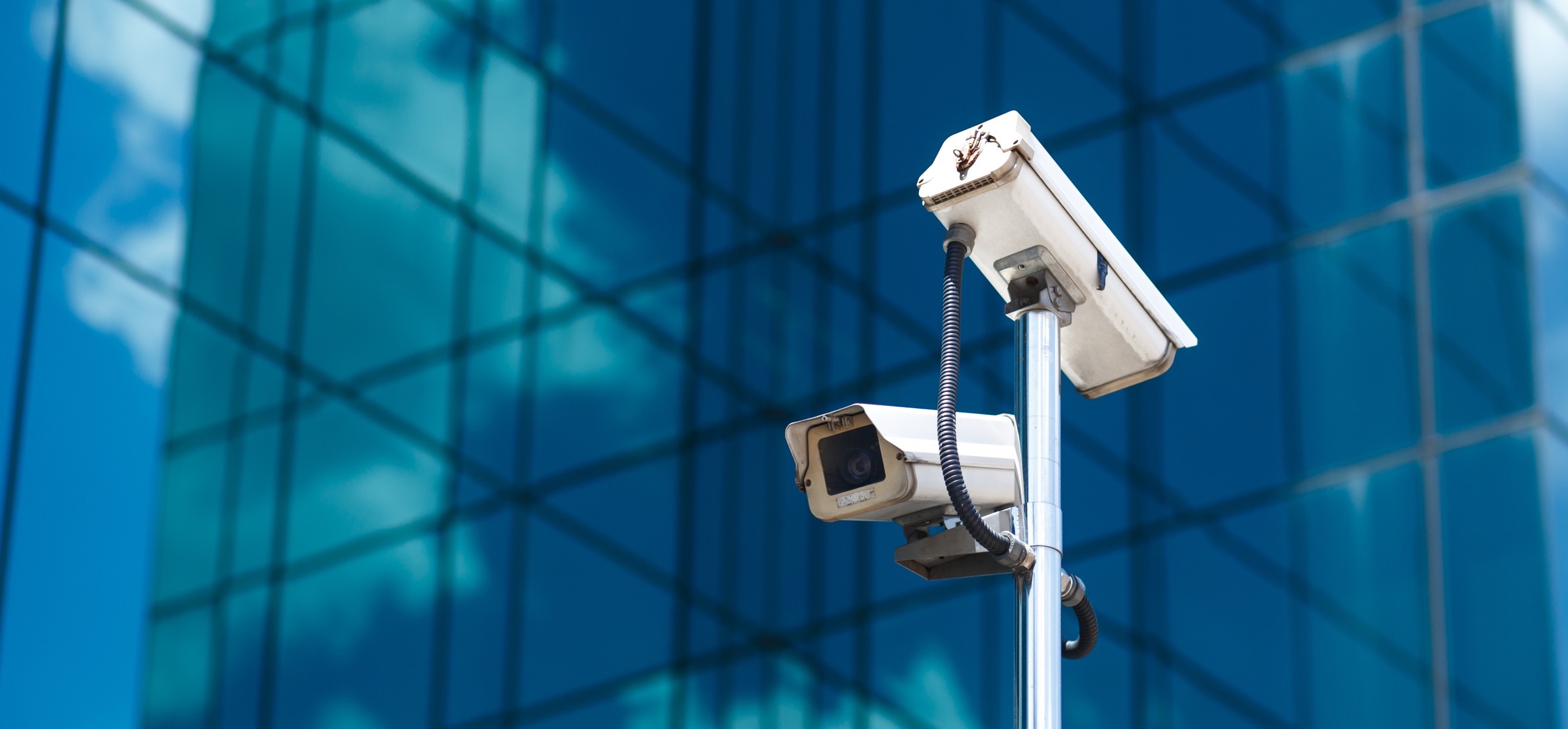 Video surveillance cameras on a commercial glass building